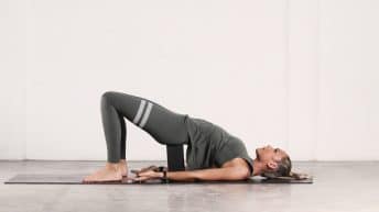 Supported Bridge pose opens up the hips and relieves pressure on the knees