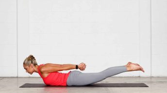 Abi Carver demonstrating core-strengthening yoga pose—Locust